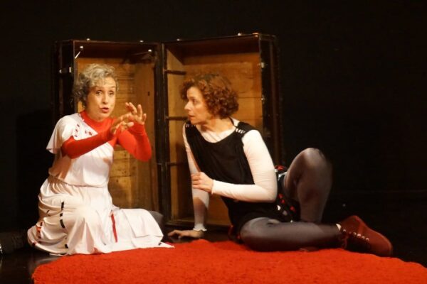 Atores em cena de "Amor de Alecrim" em Nova Friburgo, com figurinos e cenário teatral.