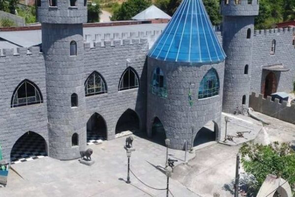 Casa-castelo medieval dos artistas Alexandre e Rosaura Shiachticas, com torreões, arte e carros antigos.