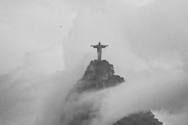 Cristo Redentor no topo do Corcovado, envolto em névoa, Rio de Janeiro.