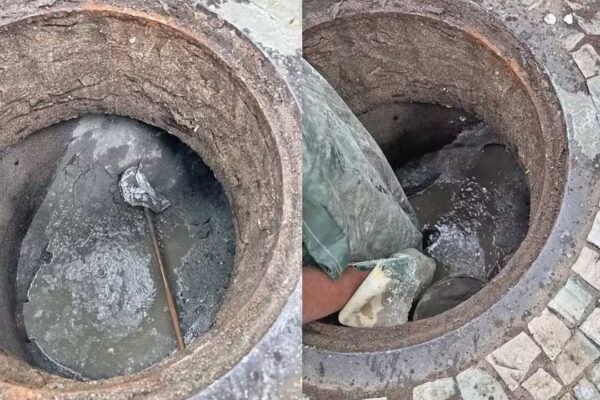 Esgoto entupido: homem inspeciona bueiro com cimento, possível obstrução por concessionária.