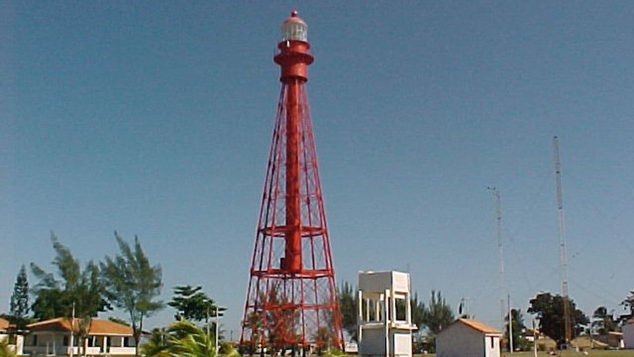 Farol de São Thomé, estrutura vermelha similar à Torre Eiffel, em dia ensolarado.
