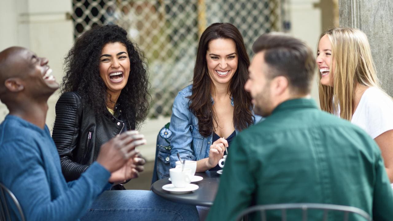 Grupo de amigos rindo e se divertindo juntos ao ar livre