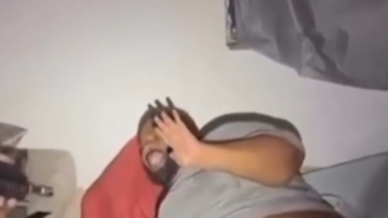 Homem com as mãos no rosto em situação de pânico, possivelmente durante uma prisão.
