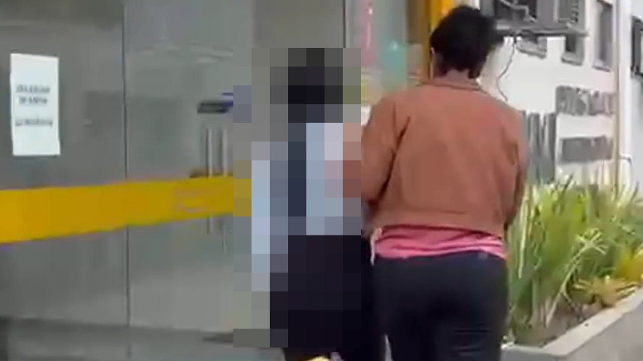 Mulher é presa por denunciação caluniosa em frente a um prédio.