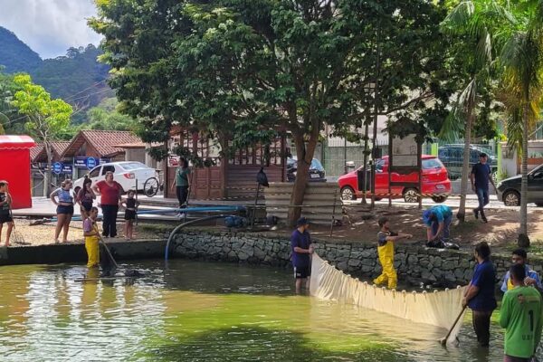 Pessoas limpando o lago de Lumiar, em Nova Friburgo.