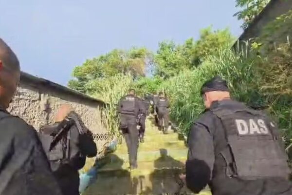 Polícia subindo escadas durante operação.