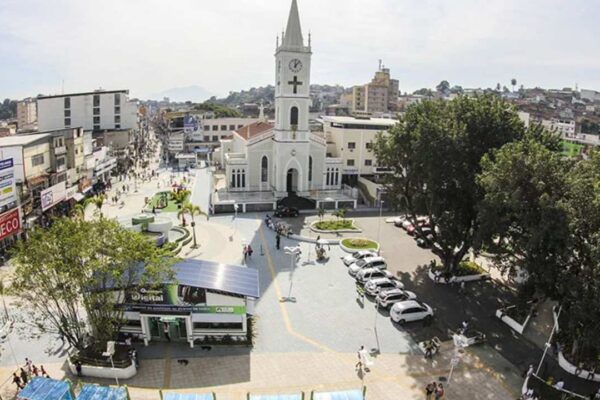 Vista aérea de São João de Meriti, com igreja, edifícios e praça.
