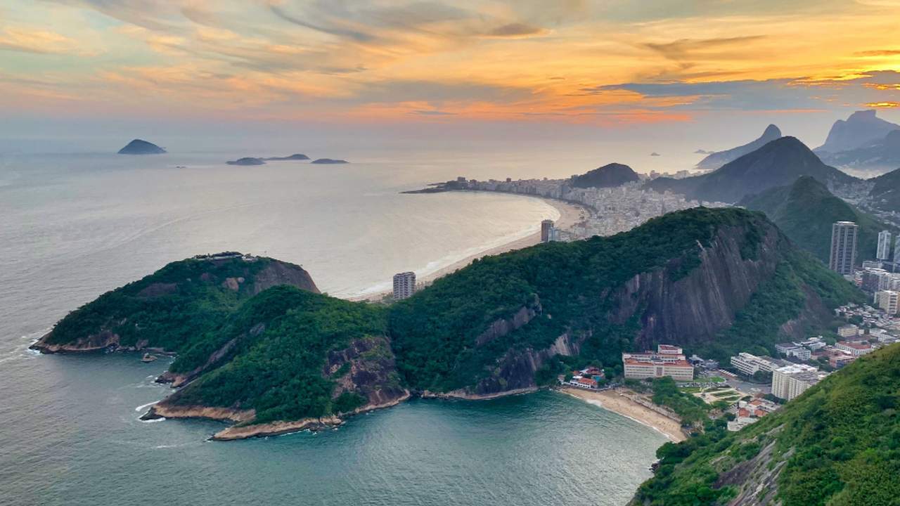 Vista panorâmica da Baía de Guanabara, com montanhas e a cidade do Rio de Janeiro ao fundo.