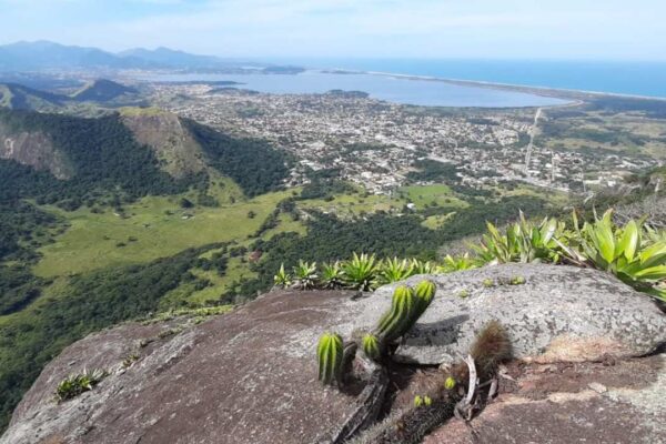 Vista panorâmica da Pedra de Inoã, em Maricá, com cidade, lagoa e mar ao fundo.