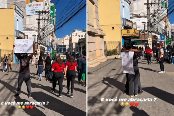 Homem vendado recebe abraço diante da Igreja de São João Batista, no Centro de Nova Friburgo