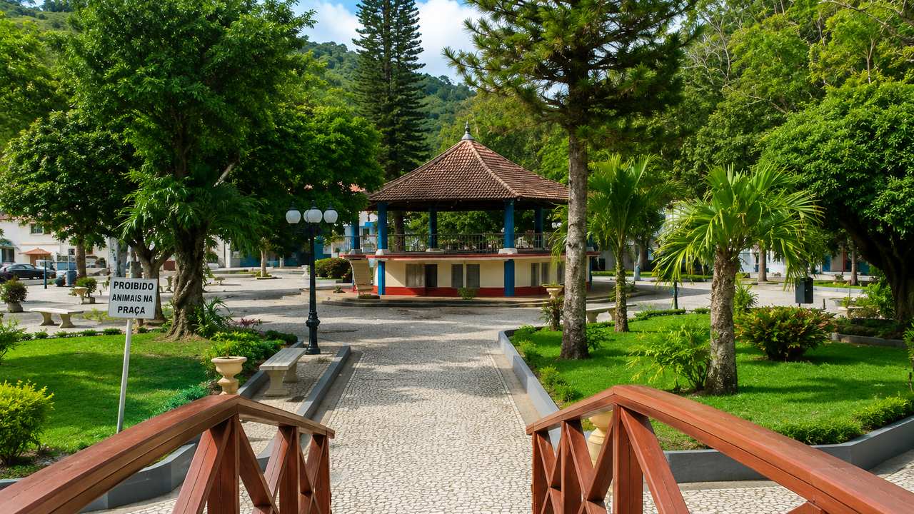 Praça arborizada em Trajano de Moraes, RJ, com coreto e paisagem.