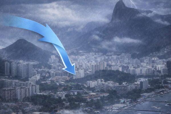 Rio de Janeiro sob chuva intensa com seta indicando queda do tempo instável