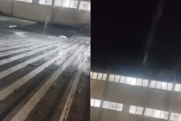 Telhado com vazamento em instalações, mostrando água e vapor.