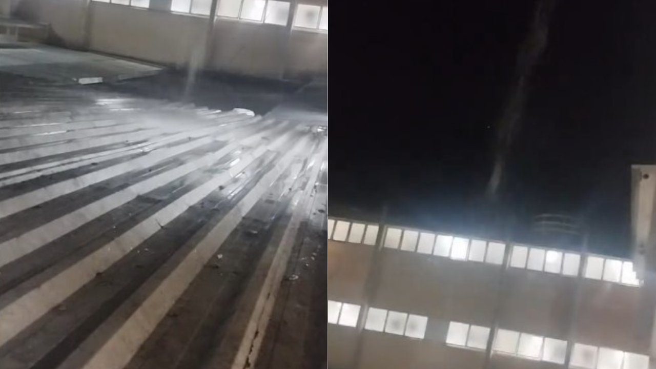 Telhado com vazamento em instalações, mostrando água e vapor.
